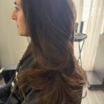 Classic Sassoon Haircut with low layers and cascading curtain angles.